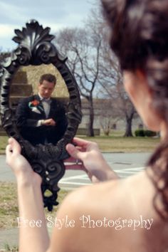 a man in a tuxedo looking at his reflection in a mirror