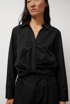 Collared long-sleeve top in a subtle pinstriped shirting. Relaxed front button placket and flattering gathered hemline. Perfect for everyday wear. Pair with the No.6 Baxter Pant in Midnight Pinstripe for a full power suit look. Chic Pinstripe Tops For Work, Pinstripe Button-up Business Tops, Pinstripe Long Sleeve Office Tops, Chic Pinstripe Shirt For Work, Chic Pinstripe Shirt For Workwear, Pinstripe Blouse With Striped Collar For Work, Pinstripe Top With Striped Collar For Business Casual, Classic Pinstripe Blouse For Work, Pinstripe Button-up Blouse For Work