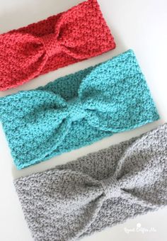 three crocheted headbands with bows on them sitting next to each other