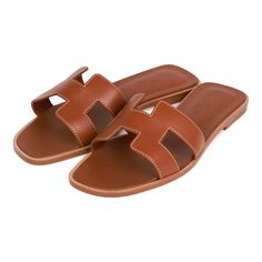 This pair of Oran Sandals are in gold box leather with contrast stitching and feature the iconic H crossover strap. Origin: ItalyCondition: Pristine; new or never wornAccompanied by: Hermes box, dustbags, carebook and ribbonSize: 36 EU Hermes Oran Sandals, Hermes Oran, Hermes Box, Gold Box, Black Box, Contrast Stitch, Crossover, Black Sandals, Calf Skin