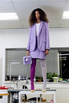 a woman standing on top of a white table