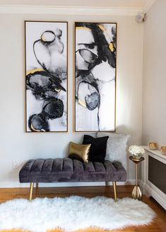 a living room with two paintings on the wall