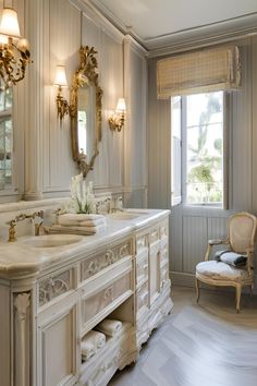 a large bathroom with two sinks, mirrors and a chair in front of the window