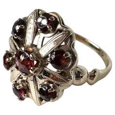 Vintage garnet rign made in cocktail style with stunning red garnets! The ring is made in 14KT yellow gold with delicate filigree artwork on the ring. GOLD: 14KT gold NATURAL garnet(S) Clarity/Color: Slightly Included/Brownish Red Carat:1.10ct Grams:3.42 size: 6.75 Item#: 200-00060MAO WHAT YOU GET AT STAMPAR JEWELERS: Stampar Jewelers, located in the heart of Jupiter, Florida, is a custom jewelry store and studio dedicated to providing 100% satisfaction to each client. Our personal attention to Garnet Ring With 17 Jewels, Victorian Ruby Cluster Ring With Gemstones, Ornate 14k Gold Ruby Ring For Anniversary, 14k Gold Filigree Ruby Ring Gift, Ornate Garnet Round Rings, Fine Jewelry White Gold Garnet Rings, Ornate Round Garnet Rings, 14k Gold Ruby Ring With Filigree For Gift, Formal Garnet Rings Fine Jewelry