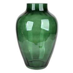 a large green vase sitting on top of a white table