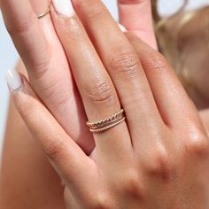 Model wearing 14k gold fill SoHo Ring Set on the middle finger. This Ring set highlights each one of our go to stacking rings including the stacking ring, spiral ring, and sequins ring. These rings are made to live in made to wear everyday. Elegant Hammered Midi Rings For Wedding, Elegant Stacked Rings As A Gift, Elegant Stackable Rings As Gift, Elegant Gift Stackable Rings, Stacked Wedding Rings Jewelry, Elegant Hammered Stackable Promise Rings, Hammered Stackable Rings For Wedding, Modern Twist Stackable Adjustable Midi Rings, Adjustable Stackable Midi Rings With A Modern Twist