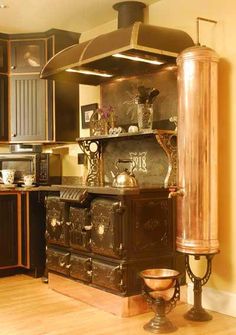 an old fashioned stove in the middle of a kitchen