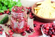 cranberry salsa in a mason jar surrounded by other ingredients