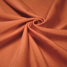 a close up view of an orange colored fabric that is very soft and smooth looking