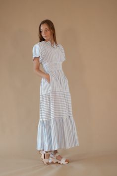 Ingrid Striped Dress – Twirl Boutique Elegant Striped Maxi Dress For Daywear, Striped V-neck Maxi Dress For Daywear, Blue Tiered Skirt Dress With Elastic Waistband, Striped Maxi Dress For Daywear, Striped Midi Dress With Smocked Bodice, Blue Maxi Dress With Smocked Bodice And Tiered Skirt, Blue Tiered Maxi Dress For Day Out, Blue Tiered Maxi Dress For Daywear, Casual Striped Smocked Dress With Smocked Back