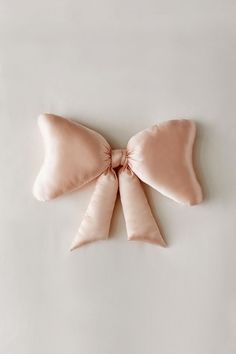 the bow pillow is made from satin material