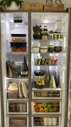 an open refrigerator filled with lots of different types of vegetables and fruit in it's doors