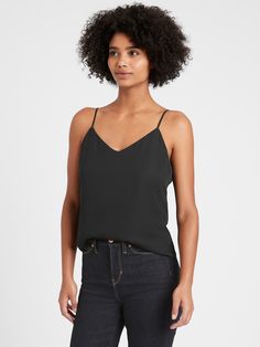 The perfect layering piece, this versatile camisole works well on its own or underneath your favorite blazer and is made in one of our easy care fabrics.  V-neck.  V-back.  Adjustable slider straps.  Straight hem.  Fully lined.  Semi-fitted with room through the chest, arms and waist.  Hits at the low hip.  Center front length (size S): Petite 14", Regular 15", Tall 16. 5" Model: Size XS, 5'10" (178cm). Black Ankle Pants, Blouse Tank Top, Black Camisole, Nude Pumps, Classic Outfits, Work Fashion, Holiday Outfits, Tank Top Shirt, Casual Looks