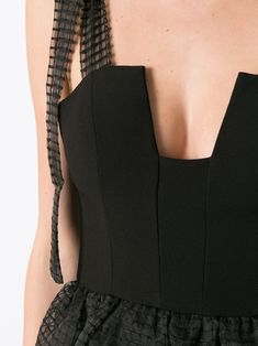 the back of a woman's black dress