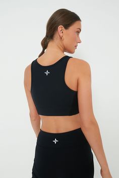 The Black Cane Jean Sports Bra is your ideal athletic bra- featuring heavy weight compression and quick dry properties, you are sure to be comfortable and secure for day-long activities. Scoop neck Reflective logo on back Power mesh interior Compression support Quick dry and wicking properties Material: 88% Nylon, 12% Spandex (main), 82% Nylon, 18% Spandex (mesh interior) Care: Gentle machine wash on cold, line dry Black Compression Activewear With Built-in Padding, Black Compression Tops With Medium Bust Support, Supportive Black Activewear With Built-in Padding, Black Sports Bra With Built-in Padding For Training, Black Sports Bra With Built-in Padding For Gym, Black Compressive Technical Activewear, Black Activewear With Mesh Back, Compressive Black Sweat-resistant Activewear, Black Sportswear Activewear With Mesh Back