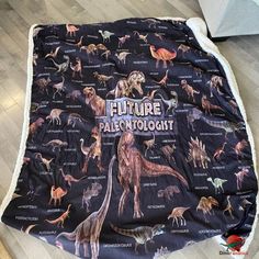 a blanket with dinosaurs on it that says future palentologists in large letters