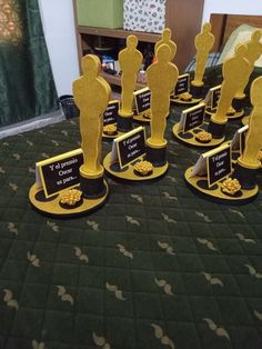 there are many awards on the table with black and gold decorations in front of them