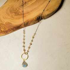 The circle stone earrings have been so popular we decided to create a necklace to match! We've combined our most popular gemstones with wire wrapped rosary chain and gold plated bar chain. This style is elegant and a simple statement.⬩8mm Heart Briollete shape Gemstone⬩18-inch Gold Plated Pendant Link necklace⬩Available in Aqua Chalcedony, Labradorite, or Moonstone This item will ship with gemstone information on the Santore Jewelry Card included with purchase.Handmade to Order Spiritual Beaded Chain With Round Pendant, Spiritual Beaded Chain Jewelry With Round Pendant, Gold Wire Wrapped Sterling Silver Crystal Necklaces, Spiritual Round Pendant With Beaded Chain, Spiritual Style Round Pendant With Beaded Chain, Gold Moonstone Gemstone Beads Necklace, Gold Labradorite Necklace With Gemstone Beads, Gold Moonstone Necklace With Gemstone Beads, Gold Labradorite Crystal Necklace With Gemstone Beads