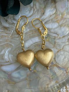 A fantastic pair of silver gilt puffy heart earrings featuring brushed metal puffy heart charms hanging from chains and set off with a really lovely art deco style fan-design motif on the lever back fastenings.  The earrings have a drop length of around 2.5cm and are in really great condition. marked '925' for sterling silver. Elegant Gold Clip-on Heart Earrings, Gold Heart-shaped Clip-on Jewelry, Gold Heart-shaped Clip-on Earrings For Wedding, Valentine's Day Gold Clip-on Jewelry, Elegant Gold Handmade Heart Earrings, Elegant Handmade Yellow Gold Heart Earrings, Gold Clip-on Heart Earrings For Valentine's Day, Handmade Double Heart Gold Earrings, Handmade Gold Double Heart Earrings