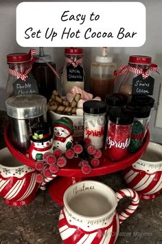 a red tray topped with cups and saucers filled with candy canes next to a sign that says how to set up a hot cocoa bar