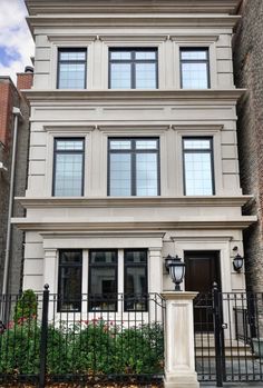 an apartment building with many windows on the front and side of it's facade