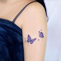 two purple butterflies on the left shoulder