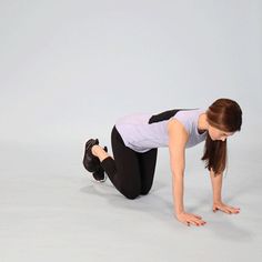 a woman is doing push ups on her knees