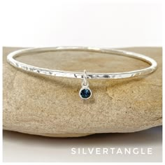 "Round hammered style bangle handmade from solid sterling silver 2.5mm thick.  It is fully hallmarked by the Edinburgh Assay Office (see photos).   Comes packaged in a lovely grey gift box AND includes a free 2\" polishing square to keep your silver tarnish free! The outside of the bangle has a lovely textured finish which gives the bangle a hammered appearance and really catches the light.  Attached to the bangle with a soldered ring is a Swarovski Crystal birthstone charm for December in the c Timeless Silver Bracelet, Simple Silver Bangles Design, Lovely Grey, Sterling Silver Thumb Rings, Silver Jewelry Diy, Diamond Pendants Designs, Hammered Bangles, Handmade Silver Jewellery, The Bangles