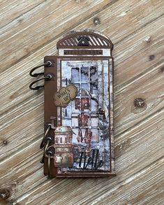 an altered book is sitting on a wooden table