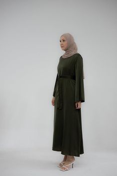 Experience comfort with the Yasmin Slip Dress. This exquisite garment has a maxi length, detachable belt, and kimono sleeves that together create an exquisite, timeless silhouette. Crafted with exquisite attention to detail, it exudes class and grace suitable to wear under abayas or coat or cardigan. Cosmopolitan yet modest, the Yasmin Slip Dress is perfect for adding a touch of glamour to all your special occasions. With its modern silhouette and opulent fabric, it’s the perfect choice for find Spring Green Maxi Length Abaya, Dark Green Abaya, Green Fitted Long Sleeve Abaya, Slip Dress Maxi, Green Bohemian Abaya With V-neck, Green Maxi-length Evening Abaya, Belt Kimono, Modest Activewear, Full Coverage Swimsuit