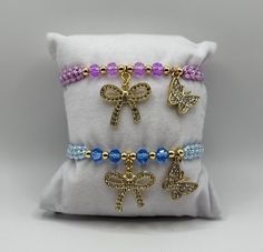 Our Butterfly and Bow Charm Bracelet makes the perfect gift for friends and family. The bracelet is adjustable and fits most wrists but can be made smaller or larger upon request. Due to the nature of the jewelry, avoid getting it wet or exposing it to lotions, perfumes, etc to ensure a long-lasting bracelet and prevent tarnishing. If you have any questions, please message us. Thank you for supporting our small business! Adjustable Purple Bracelet Gift, Adjustable Purple Bracelet For Gift, Adjustable Purple Bracelets For Gifts, Adjustable Purple Bracelets As A Gift, Adjustable Purple Beaded Bracelet Gift, Adjustable Bangle Stretch Bracelet For Gift, Adjustable Jubilee Stretch Bracelet As Gift, Adjustable Bangle Stretch Bracelet As Gift, Adjustable Stretch Bangle Bracelet As Gift