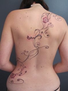 the back of a woman's body with flowers on it