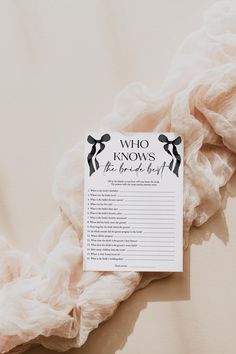 a sign that says who knows the bride to be? on top of a blanket