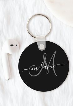 personalized round keychain with monogrammed name and initial on black background