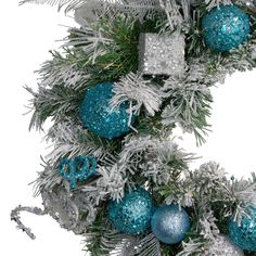 a christmas wreath with blue and silver ornaments