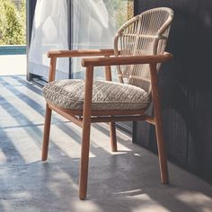 a wooden chair sitting next to a window