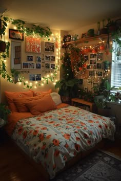 a bedroom decorated with plants and pictures on the wall, lights strung from the ceiling