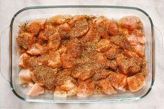 a glass casserole dish filled with meat and seasoning