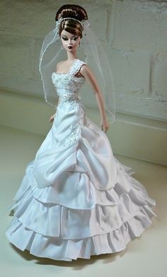 a barbie doll wearing a wedding dress and veil