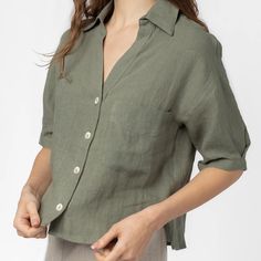 Never Worn. Lightweight Short Sleeve Shirt. The Dawn Top Features A Deep V-Neckline And Buttons Down The Front. This Style Is Perfect For Vacation And Summer Days. - 100% Linen - V-Neck - Collared Relaxed Fit V-neck Top With Button Closure, Solid Linen V-neck Shirt, Linen V-neck Shirt, Olive Short Sleeve Top For Summer, Green V-neck Shirt For Day Out, Summer Olive Tops With Relaxed Fit, Summer Olive Relaxed Fit Tops, Versatile V-neck Relaxed Fit Shirt, Olive Relaxed Fit Summer Tops