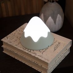 a white light sitting on top of a book