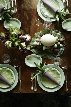 an image of a table setting with plates and utensils on top of it