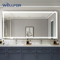 a bathroom with two sinks and a large mirror on the wall above it is illuminated by lights