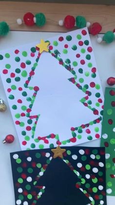 christmas tree card made from construction paper and pom - poms on the table