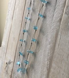 Caribbean aqua blue sea glass and silver beads are hand knotted in this versatile and stylish 22 inch FREESTYLE wrap! Wear it as a necklace, lariat, choker, triple wrap bracelet, double wrap anklet, even as a hair crown or accent braid! Our special infinity loops allow you to tuck the end in anywhere along the cord, or let it dangle! You can even connect them together using the loop and ball to create a stunning stacked and layered look! As with all handmade items, please allow for slight variat Blue Sea Glass Necklace, Coastal Cottage Decorating, Triple Wrap Bracelet, Island Jewelry, Hair Crown, Bracelet Metal, Blue Sea Glass, Sea Glass Necklace, Glass Necklace