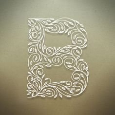 the letter e is made up of swirls and leaves