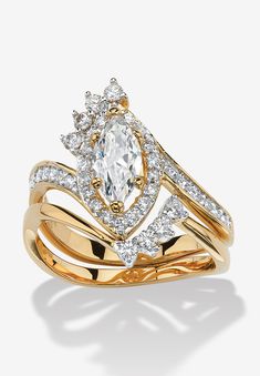 a yellow gold ring with an oval cut diamond surrounded by smaller round diamonds on each band