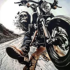 a man riding on the back of a motorcycle next to a road with skulls painted on it