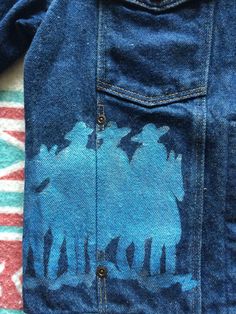 This is an amazing vintage denim jacket that needs a new home for fall. If you want to look and be incredible during this season, get it in your life now. There are no rips, holes, or stains. The hand painted cowboys look awesome and will make you feel great. Measurements: Pit to pit: 18 1/2 inches Collar to bottom front: 19 inches Collar to bottom back: 22 inches Sleeve Length (from collar): 27 inches Size on tag: Small (check measurements for length) Western Blue Denim Jacket For Fall, Western Style Denim Blue Jacket For Fall, Western Style Cotton Denim Jacket For Fall, Cotton Denim Jacket With Pockets For Rodeo, Fitted Western Cotton Denim Jacket, Pre-washed Denim Jacket For Fall, Pre-washed Denim Blue Jacket For Fall, Fall Rodeo Denim Jacket, Vintage Medium Wash Denim Jacket For Rodeo