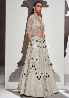 Dripping with eclectic mirror embellishments, scintillating silhouettes, and luxurious fabrics, our anora lehenga set is a masterpiece of sartorial artistry. The set features an opulently handcrafted lehenga and a stunning blouse, elegantly paired with a heavily embellished short jacket. Eclectic Mirror, Eclectic Mirrors, Fashion Studies, Jacket Lehenga, Traditional Indian Dress, Embellished Shorts, Indian Dress, Indian Fabric, Study Style